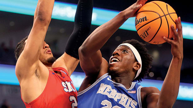 Memphis Tigers forward Malcolm Dandridge shoots the ball over SMU Mustangs forward Isiah Jasey during their AAC Tournament game at Dickies Arena in Fort Worth.